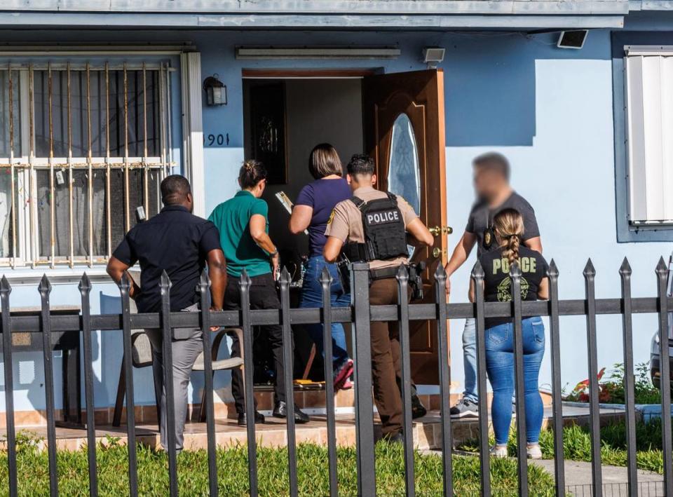 Miami-Dade County Police officers serve a search warrant Saturday, Jan. 27, 2024, on a home at 11901 SW 185th Terrace that detectives say was operating as an unlicensed veterinary clinic.