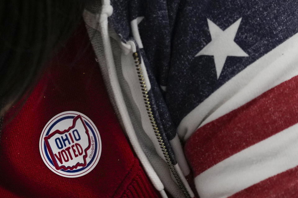 A poll worker has and "Ohio Voted" sticker on her shirt during early in-person voting at the Hamilton County Board of Elections in Cincinnati, Wednesday, Oct. 11, 2023. (AP Photo/Carolyn Kaster)