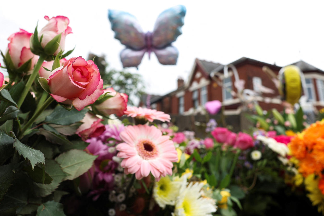 Floral tributes lie near the scene where a teenage suspect was arrested 