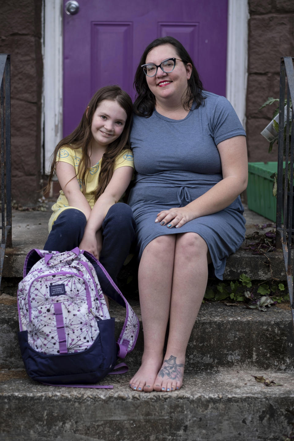 Abby Norman, right, said her 9-year-old daughter Priscilla Norman, left, was in tears the first morning of school testing because she felt pressure to do well, but didn't feel prepared after remote learning, sitting outside at the family's home in Decatur, Ga., Tuesday, May 18, 2021. (AP Photo/Ben Gray)