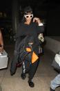 <p>In a black sweatshirt with Off-White c/o Virgil Abloh sweatpants, a camo backpack, black hat, white RAEN sunglasses, and Fenty x Puma slides at LAX airport.</p>