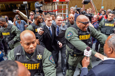 Sheriff deputies escort the family of police officer Edward Nero from the courthouse in Baltimore, Maryland, May 23, 2016. REUTERS/Bryan Woolston