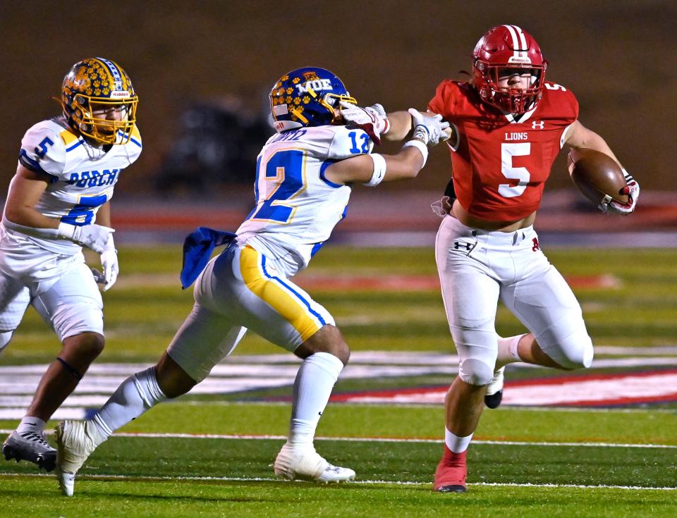 Albany running back Adam Hill stiff arms Sunray linebacker Uriel Ortiz during the Class 2A DII semifinal game Dec. 7 at Lowrey Field in Lubbock.