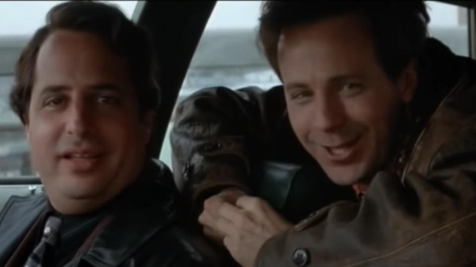 Jon Lovitz and Dana Carvey look at the camera with goofy expressions in Trapped in Paradise.