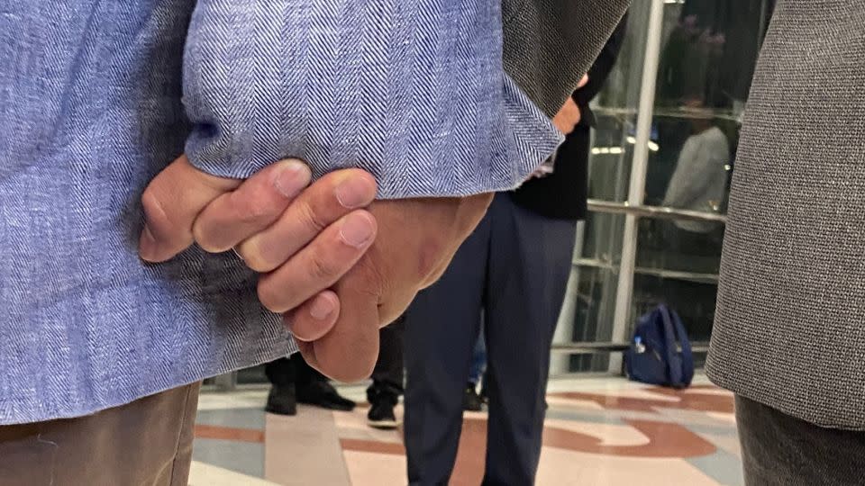 Vacharaesorn and Chakriwat Vivacharawongse hold hands during their press conference at Bangkok airport.   - CNN