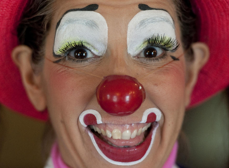 In a July 31, 2012 photo, Julie Varholdt, aka "Lovely Buttons," poses for a portrait at the third annual Clown Campin' in Ontario, Calif. The week long event is held for clowns across the United States and Canada to learn, get inspired, and network. (AP Photo/Grant Hindsley)