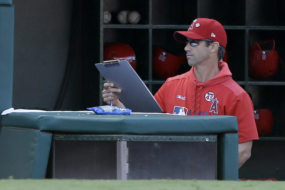 Los Angeles Angels manager Brad Ausmus picks up his clipboard after the last out in the ninth inning as the Houston Astros defeat his team in a baseball game in Anaheim, Calif., Sunday, Sept. 29, 2019. (AP Photo/Alex Gallardo)