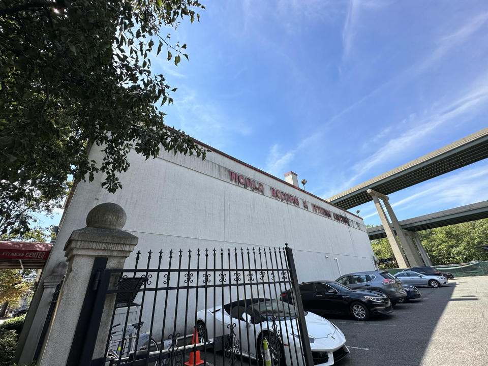 <p>A photo from the iPhone 14 Pro's wide camera featuring an aging sign for a gym against a blue sky.</p>
