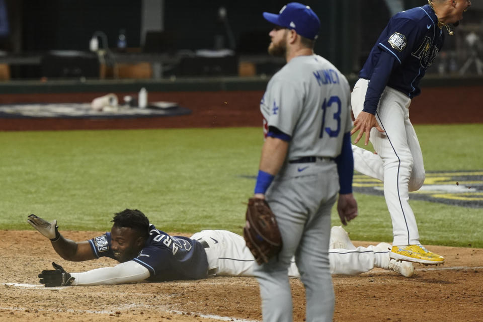 Tampa Bay Rays' Randy Arozarena celebrates after scoring the winning run in Game 4 of the baseball World Series against the Los Angeles Dodgers Saturday, Oct. 24, 2020, in Arlington, Texas. Rays defeated the Dodgers 8-7 to tie the series 2-2 games. (AP Photo/Eric Gay)