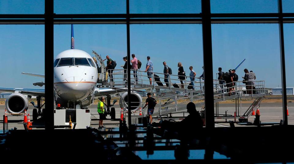 Passengers board a departing United Express jet at the Tri-Cities Airport in Pasco.