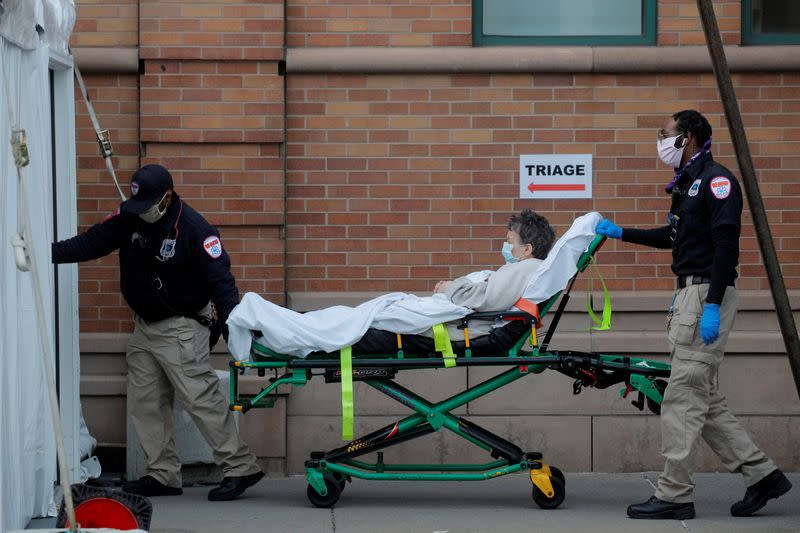 Paramedics take a patient into the emergency center at Maimonides Medical Center during the outbreak of the coronavirus disease (COVID-19) in Brooklyn