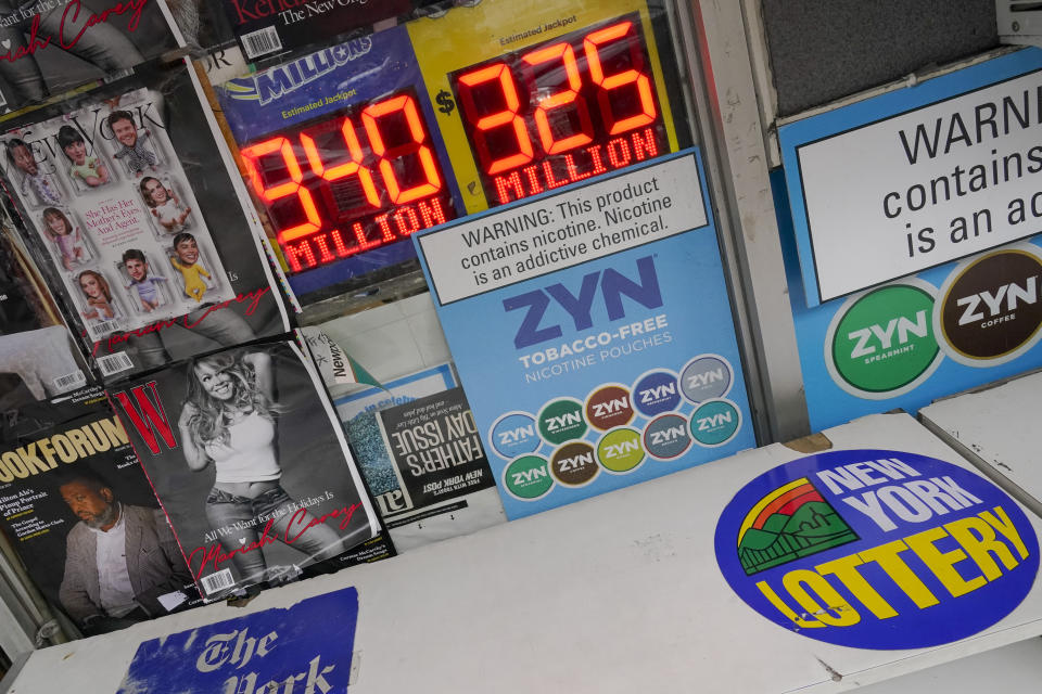 A sign announcing the $940 million Mega Millions Lottery jackpot is seen outside a convenience store on the Upper East Side of Manhattan, Friday, Jan. 6, 2023 in New York. (AP Photo/Mary Altaffer)