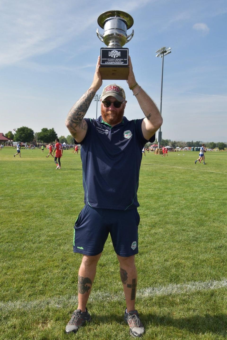 Damon Margida holds up Gerry McKnight Memorial Cup after leading the Cleveland hurling club to the United States Gaelic Athletic Association's Junior D national title in Denver.