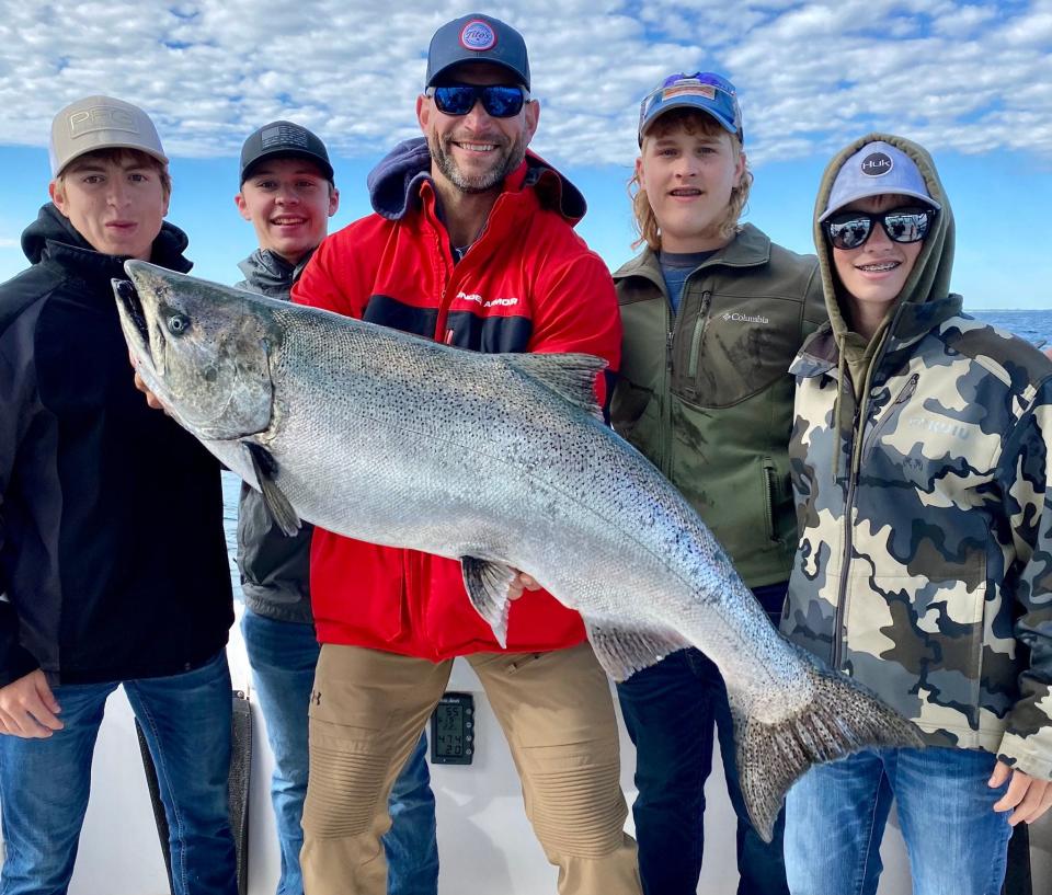 Joe Thomas of Madison holds a 37-pound chinook salmon caught in Lake Michigan off Milwaukee by Sawyer Conner of Muscoda, second from right.