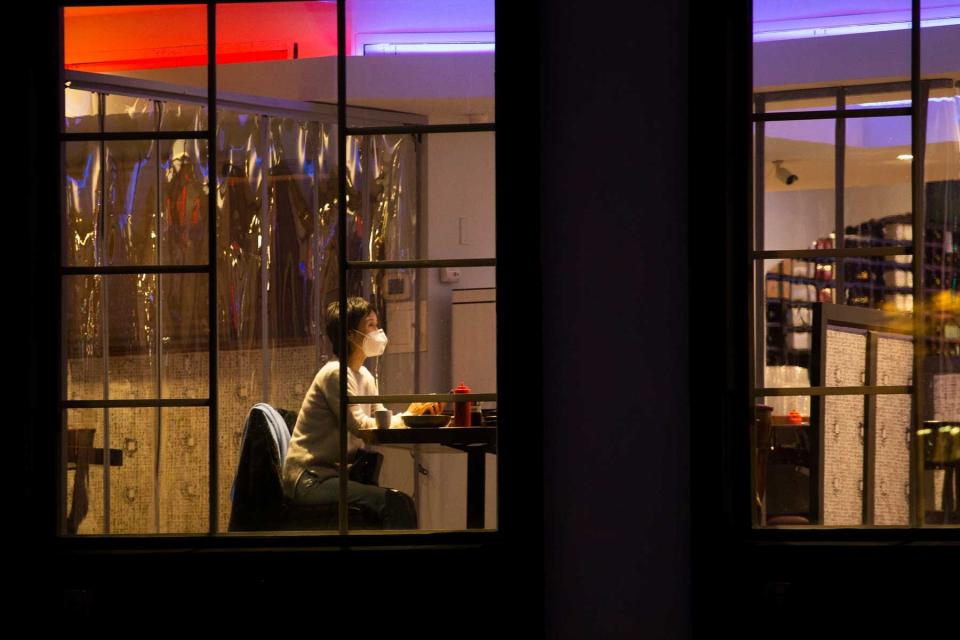 A person wears a facemask as they sits inside the restaurant Bada Story in Fort Lee, New Jersey on February 6, 2021, amid the coronavirus pandemic