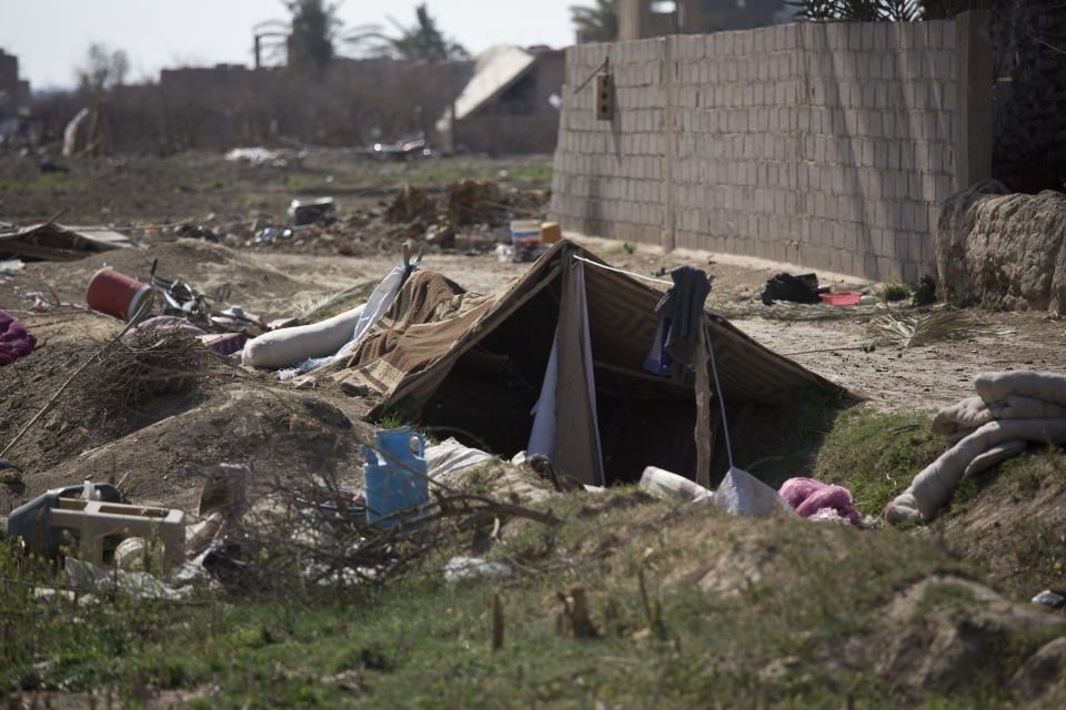 A tent is pitched over a trench left behind by Islamic State militants, in Baghouz, Syria, as U.-S.-backed Syrian Democratic forces continued their push to oust IS from their last territory, Monday, March 11, 2019. (AP Photo/Maya Alleruzzo)