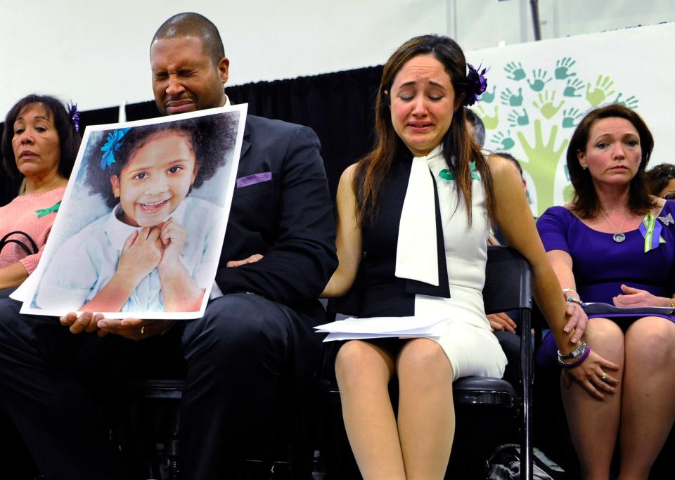 Jimmy Greene, foreground left, Nelba Marquez-Greene, center, parents of Sandy Hook Elementary School shooting victim Ana Marquez-Greene, and Nicole Hockley, right, mother of victim Dylan Hockley, react during a news conference at Edmond Town Hall in Newtown, Conn., Monday, Jan. 14, 2013. One month after the mass shooting at the school, the parents joined a grassroots initiative called Sandy Hook Promise to support solutions for a safer community.