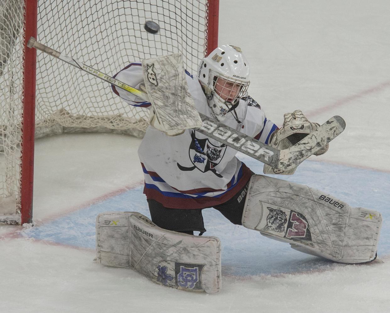 Dover-Sherborn Weston boys hockey goalie senior captain Andrew Goldstein deflects a shot against Hopedale at the MacDowell Arena at Rivers, Feb. 12, 2024.