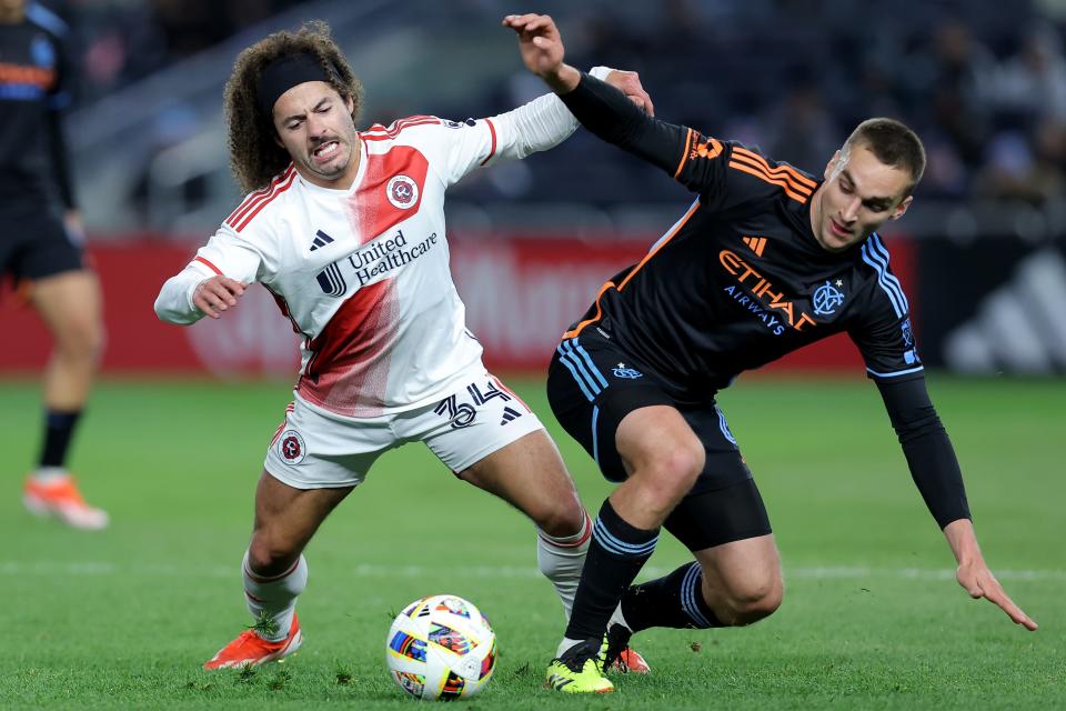 New England Revolution defender Ryan Spaulding (34) fights for the ball against New York City FC midfielder James Sands (6) during the second half at Yankee Stadium, April 13, 2024.