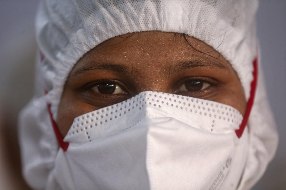 A nurse poses for a photograph inside a ward at the BKC jumbo field hospital, one of the largest COVID-19 facilities in Mumbai, India, Friday, May 7, 2021.(AP Photo/Rafiq Maqbool)