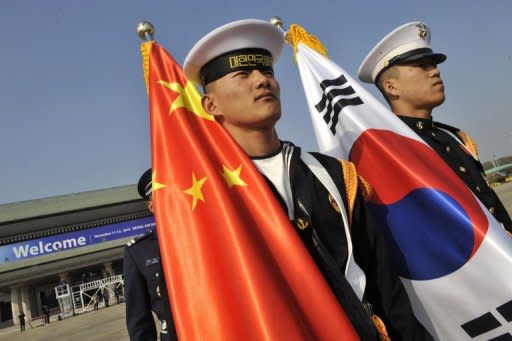 Photo illustration shows South Korean and Chinese military personnel during a military honour guard in Seoul. Three South Korean diplomats have been summoned back to the capital following allegations they had affairs with a Chinese woman, who reportedly acted as a conduit to senior Chinese officials and arranged meetings with visitors from Seoul