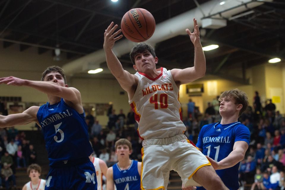 Mater Dei’s Blaine Herr (40) reaches for the rebound during the class 3A boys basketball sectional at Boonville High School on Friday night, March 3, 2023.