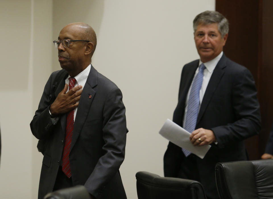 Ohio State University president Dr. Michael Drake, left, and university board of trustees chair Michael Gasser leave to go into executive session during a meeting of the trustees to discuss the future of NCAA college football coach Urban Meyer in Columbus, Ohio, Wednesday, Aug. 22, 2018. The board will meet in private to decide whether the superstar coach should be punished for the way he handled domestic-abuse allegations against a former assistant. (AP Photo/Paul Vernon)