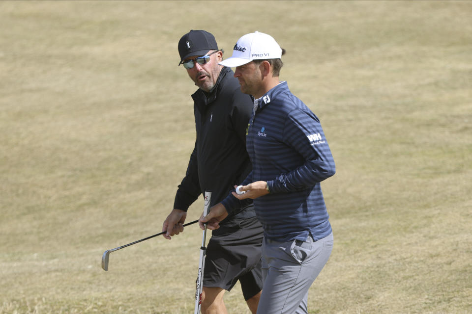 Phil Mickelson of the US, left, and Austria's Bernd Wiesberger during a practice round at the British Open golf championship on the Old Course at St. Andrews, Scotland, Wednesday July 13, 2022. The Open Championship returns to the home of golf on July 14-17, 2022, to celebrate the 150th edition of the sport's oldest championship, which dates to 1860 and was first played at St. Andrews in 1873. (AP Photo/Peter Morrison)