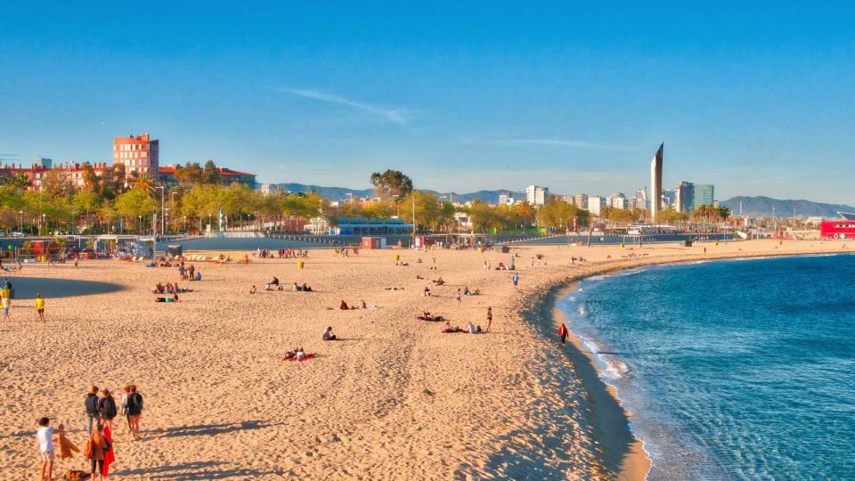 People At Beach Against Blue Sky