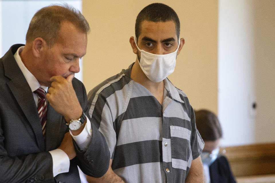 Defense attorney Nathaniel Barone, left, and Hadi Matar, 24, right, listen during an arraignment in the Chautauqua County Courthouse in Mayville, NY., Thursday, Aug. 18, 2022. Matar was arrested Aug. 12 after he rushed the stage at the Chautauqua Institution and stabbed Salman Rushdie in front of a horrified crowd. (AP Photo/Joshua Bessex)