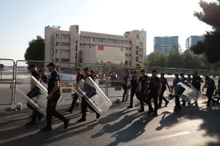 Turkish police walk in front of the Metropolitan Municipality headquarters in Diyarbakir