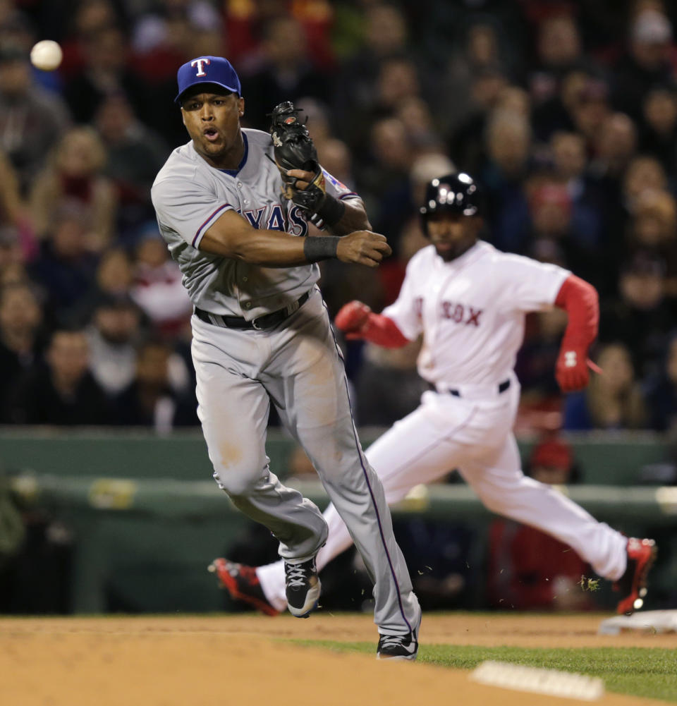 Texas Rangers third baseman Adrian Beltre, left, makes the throw on a bases loaded ground out by Boston Red Sox's Dustin Pedroia to end the second inning of a MLB American League baseball game at Fenway Park, Monday, April 7, 2014, in Boston. At rear rounding third is Red Sox Jackie Bradley Jr. (AP Photo/Charles Krupa)