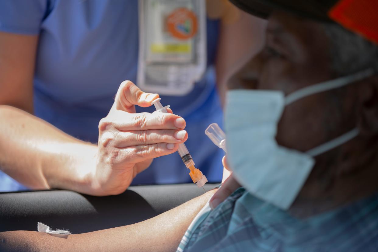 Nurse Leigh Jones administers the Johnson & Johnson-made COVID-19 vaccination to Marvin Davis at a vaccination event hosted by the Maury Regional Health Mobile Medical Unit at St. Paul AME Church in Columbia, Tenn., on Friday, March 26, 2021.