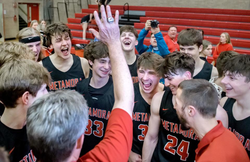 Metamora head coach Danny Grieves pumps up his players after the Redbirds 60-48 victory over Marmion Academy in the Class 3A supersectional Monday, March 6, 2023 at Ottawa High School.