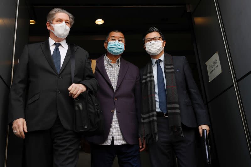 Media mogul and Apple Daily founder Jimmy Lai Chee-ying (C) leaves from a police station after being arrested for illegal assembly during the anti-government protests in Hong Kong