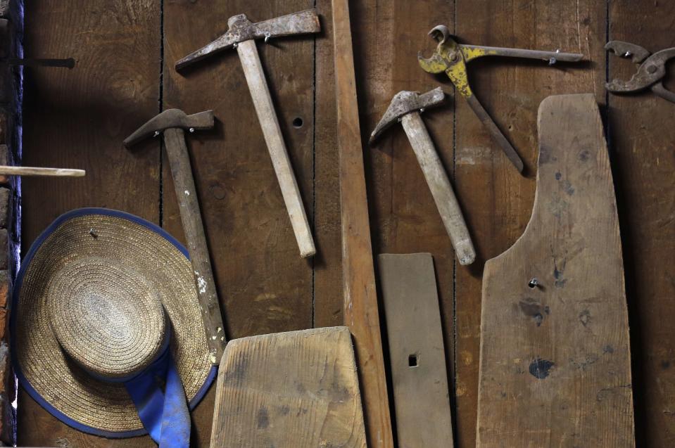 A Venetian gondoliers' hat and hammers hangs on a wall in San Trovaso boatyard, also known as a