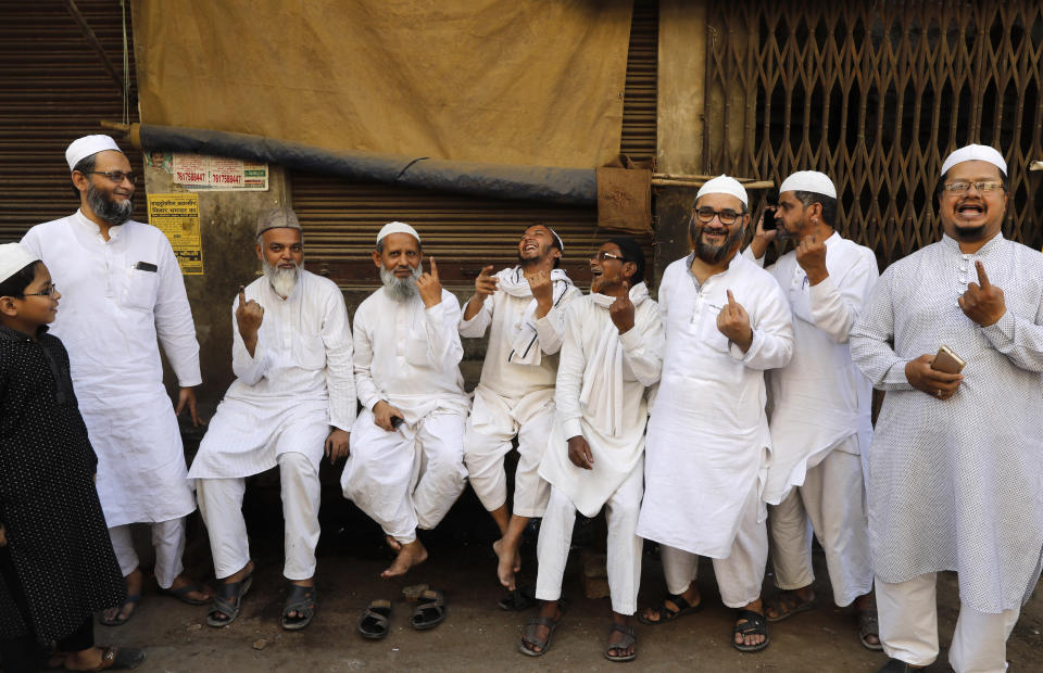 Indian Muslims display indelible ink mark on their fingers after casting their votes outside a polling station in Varanasi, India,Sunday, May 19, 2019. Indians are voting in the seventh and final phase of national elections, wrapping up a 6-week-long long, grueling campaign season with Prime Minister Narendra Modi's Hindu nationalist party seeking reelection for another five years. Counting of votes is scheduled for May 23. (AP Photo/Rajesh Kumar Singh)