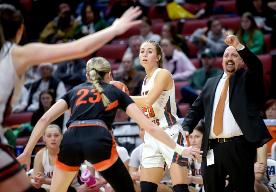 Illini Bluffs' Annabelle Fortin (20) looks to pass as coach Jim Belville directs the Tigers against Altamont in the second half of their Class 1A girls basketball state semifinal Thursday, Feb. 29, 2024 at CEFCU Arena in Normal. The Tigers defeated the Lady Indians 60-48 in overtime.