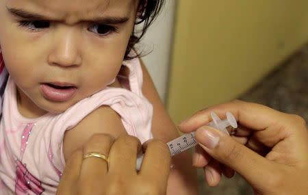 A health agent vaccinates a child during a campaign of vaccination against yellow fever in Sao Paulo, Brazil January 17, 2018. REUTERS/Leonardo Benassatto