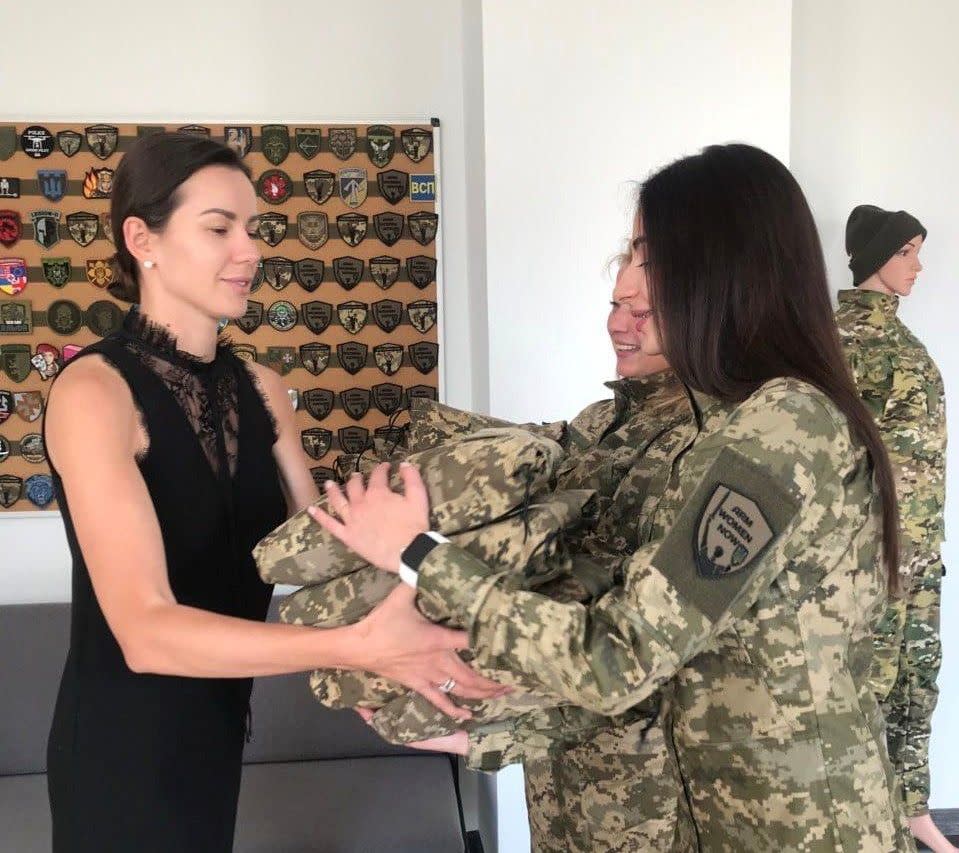 Iryna Nykorak (L), a Ukrainian lawmaker and the founder of the Arm Women Now initiative, hands uniforms to Ukraine's female soldiers. (Arm Women Now/Facebook)