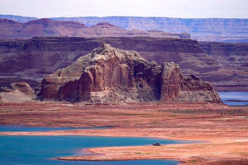 FILE - Low water levels at Wahweap Bay at Lake Powell along the Upper Colorado River Basin are shown Wednesday, June 9, 2021, at the Utah and Arizona border at Wahweap, Ariz. The Biden administration will use $1.7 billion from the recently enacted federal infrastructure bill to fund 16 tribal water rights settlements. U.S. Interior Secretary Deb Haaland announced the funding Tuesday, Feb. 22, 2022 during a visit to Arizona. (AP Photo/Ross D. Franklin,File)