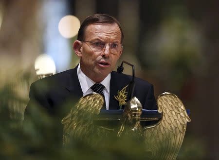 Australian Prime Minister Tony Abbott delivers remarks during a national memorial service for the victims of Malaysia Airlines flight MH17 at St Patrick's Cathedral in Melbourne August 7, 2014. REUTERS/Graham Denholm/Pool