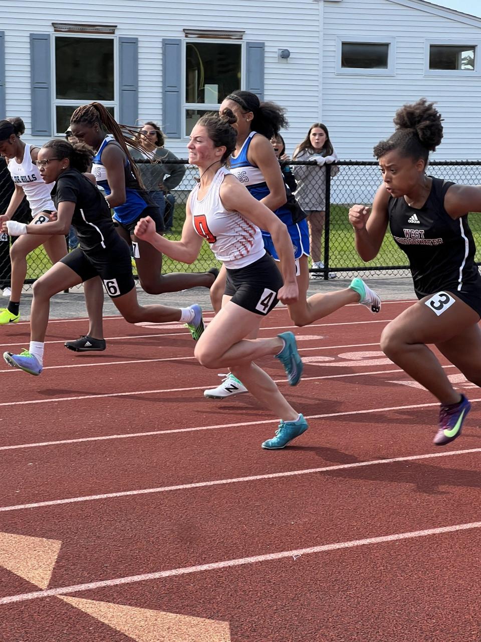 Diman's Inez Medeiros, middle, jumps in front of the field during a race this spring.
