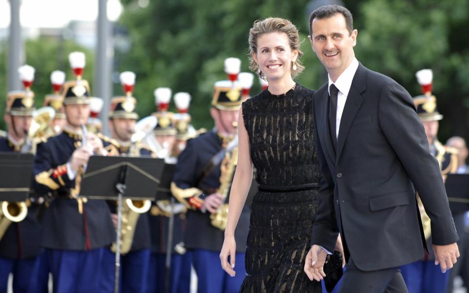 Syrian President Bashar al-Assad and his wife Asma al-Assad arrive at the Petit Palais, Paris, after attending the Union for the Mediterranean founding summit in July 2008 - Credit: GERARD CERLES/AFP