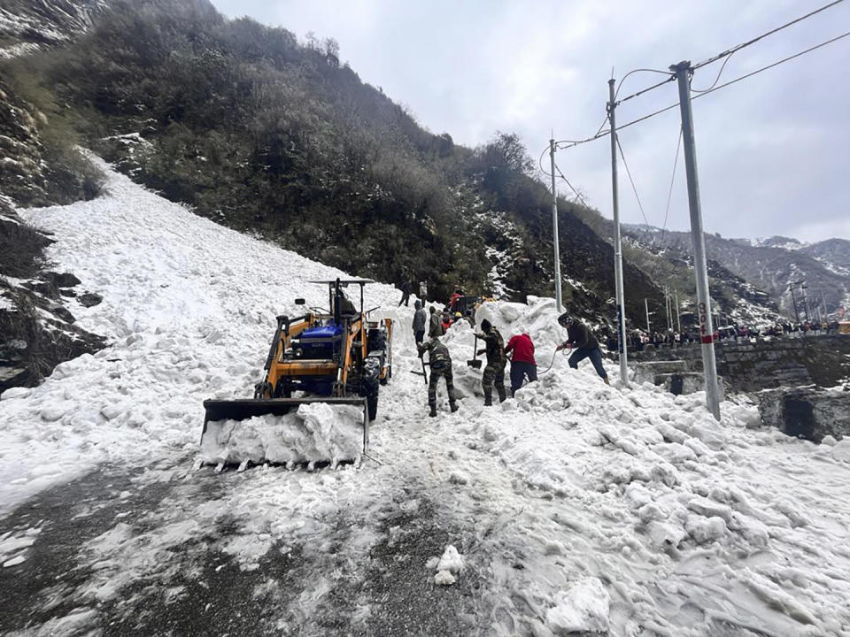 In this handout photo released by the Indian Army, soldiers clear snow from an avalanche near Nathu La mountain pass in India's Sikkim state, April, 4, 2023. / Credit: AP/Indian Army