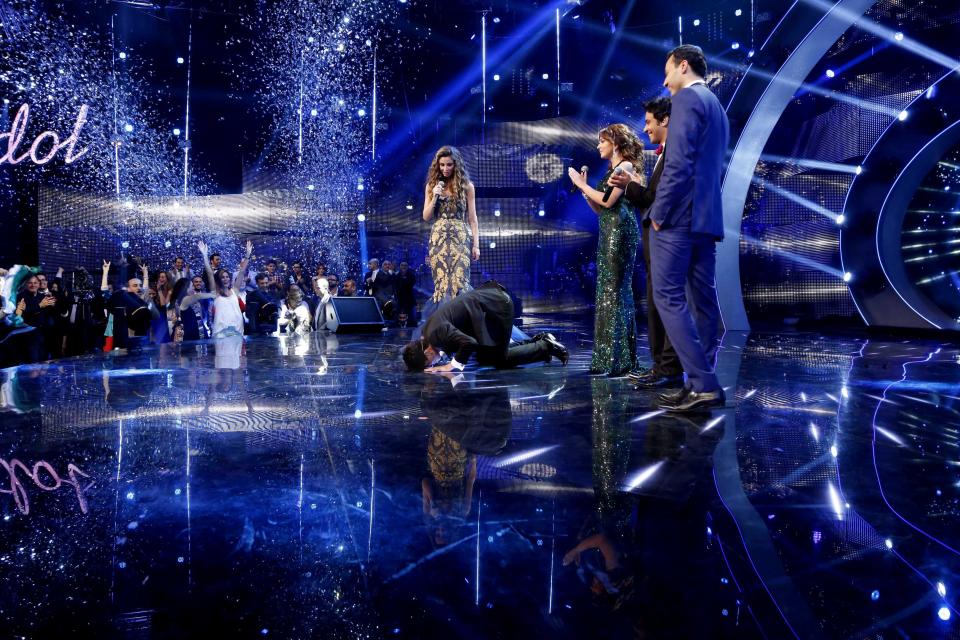 In this Saturday, June 22, 2013 photo released by the MBC Group, singer Mohammed Assaf, prays after receiving the Arab Idol award in Beirut, Lebanon. On Saturday night, Assaf became the first Palestinian to win the Arab world’s version of American Idol, setting off wild celebrations across the Palestinian territories. After the victory, Palestinian President Mahmoud Abbas declared the singer an honorary ambassador. (AP Photo/MBC Group)