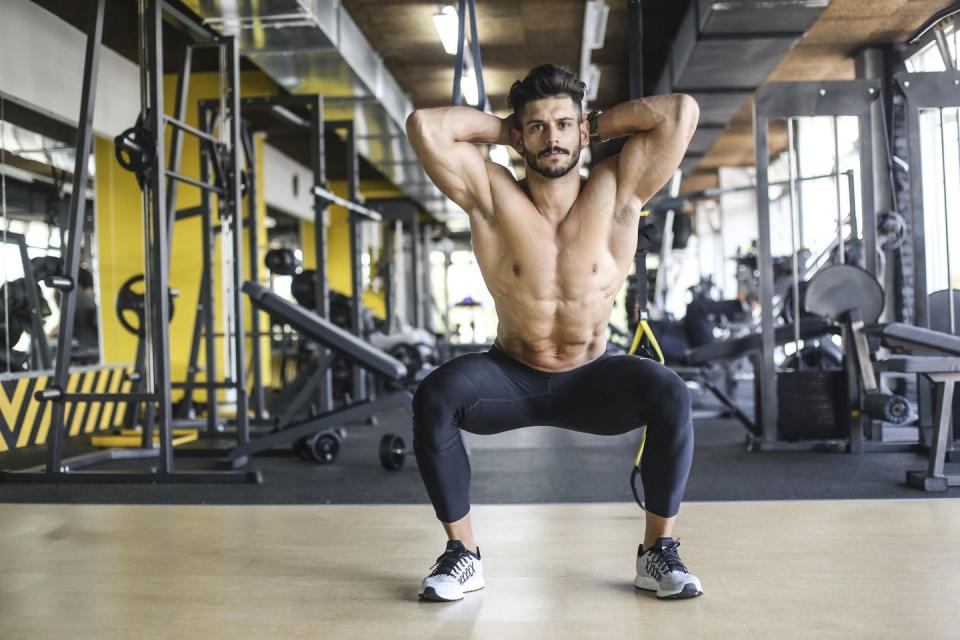 muscular man exercising squats