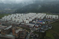 An aerial view shows apartments built by the Chinese government for ethnic minority in Yuexi county, southwest China's Sichuan province on Sept. 11, 2020. The ruling Communist Party says its initiatives have helped to lift millions of people out of poverty. Yi ethnic minority members were moved out of their mountain villages in China’s southwest and into a newly built town in an anti-poverty initiative. (AP Photo/Sam McNeil)