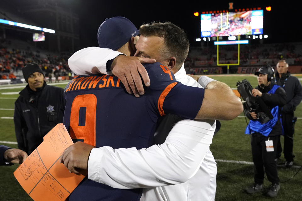 Illinois head coach Bret Bielema hugs quarterback Artur Sitkowski after the team's 9-6 win over Iowa in an NCAA college football game Saturday, Oct. 8, 2022, in Champaign, Ill. (AP Photo/Charles Rex Arbogast)
