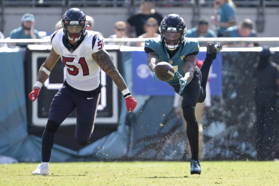 Jacksonville Jaguars wide receiver Zay Jones (7) can't make the catch as Houston Texans linebacker Kamu Grugier-Hill (51) defends during the second half of an NFL football game in Jacksonville, Fla., Sunday, Oct. 9, 2022. (AP Photo/Phelan M. Ebenhack)